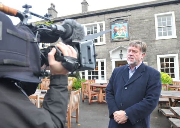 Clitheroe historian, Simon Entwistle, being filmed in Downham for the Discovery Channel.