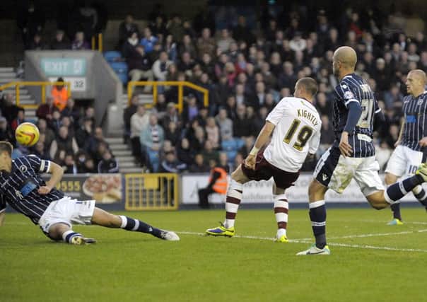 The equaliser: Michael Kightly forces home Burnleys second goal at The Den on Saturday - but is it his goal or a Shane Lowry own goal?