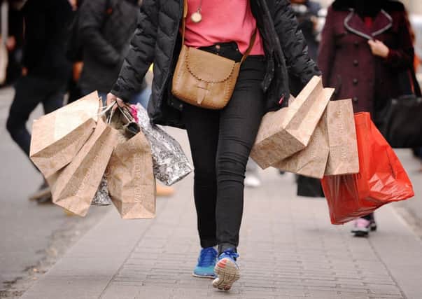 Shopper carrying shopping bags. Photo: Dominic Lipinski/PA Wire