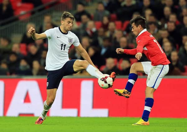 England's Jay Rodriguez battles for the ball with Chile's Eduardo Vargas