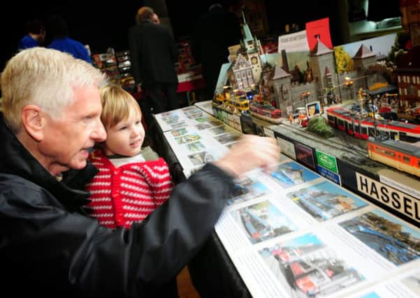 Mr Peter Carroll and his grandson 3-year-old Henry Jackson enjoy the model railway exhibition at Park High School in Colne.
Photo Ben Parsons