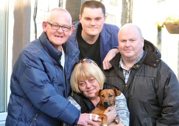 Victims of a dog attack in Burnley, Frank Smith and dog Alfie, with his family, Julie, Bradley and Gary Frayling.