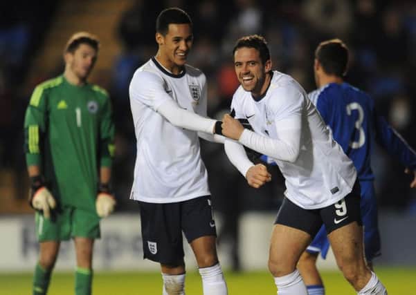 England's Danny Ings celebrates scoring the sixth goal with Tom Ince  (left) during the UEFA European U21 Championship Qualyfying match. Photo: Joe Giddens/PA Wire.