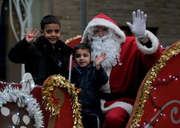 Burnley Christmas lights switch on 2013. Joel (6) and Zain Ali (4) meet Santa.
