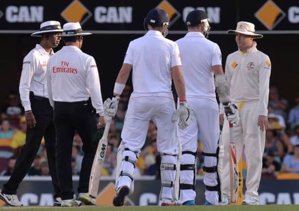 England's James Anderson (second right) exchanges words with Australia's Michael Clarke (right) during day four of the first Ashes Test at The Gabba, Brisbane, Australia. Photo: Anthony Devlin/PA Wire.
