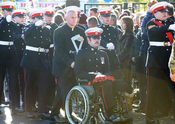 Royal Marine Alex Brewer joins the parade.