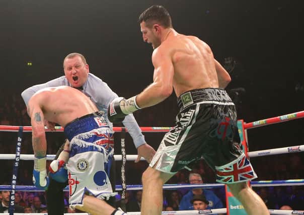 Controversial decision: Referee Howard Foster stops Carl Froch (right) and George Groves during the WBA and IBF Super Middleweight Title fight at the Phones 4u Arena, Manchester.