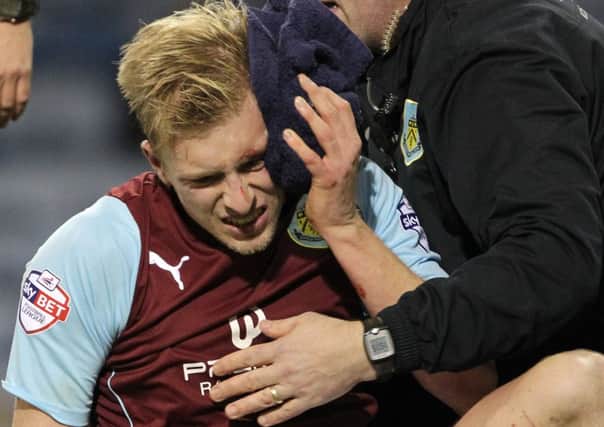 Home comforts: Ben Mee receives treatment to a head wound during the 0-0 draw with Watford on Tuesday