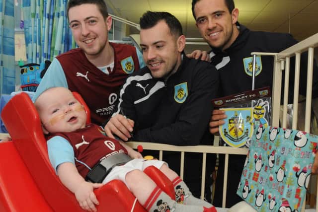 Ashley Hartley with his 10 month old son Thomas with players Ross Wallace and Danny Ings.