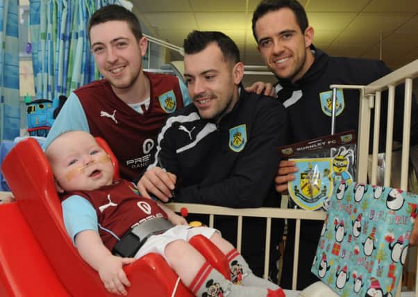 Ashley Hartley with his 10 month old son Thomas with players Ross Wallace and Danny Ings.