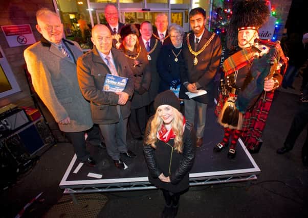 Pictured, Grace O'Malley (centre) with guests at the annual Pendleside Hospice Light Up A Life service