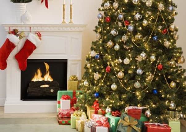 Christmas tree with presents and fireplace with stockings Photo:/Corbis