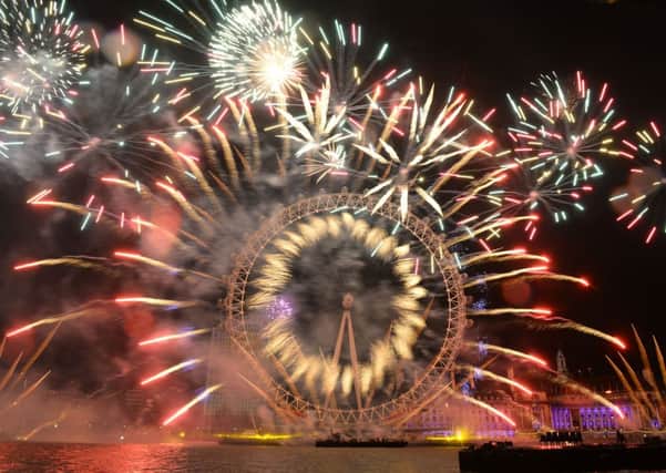 Fireworks light up the sky over the London Eye in central London during the New Year celebrations.  Photo: Dominic Lipinski/PA Wire