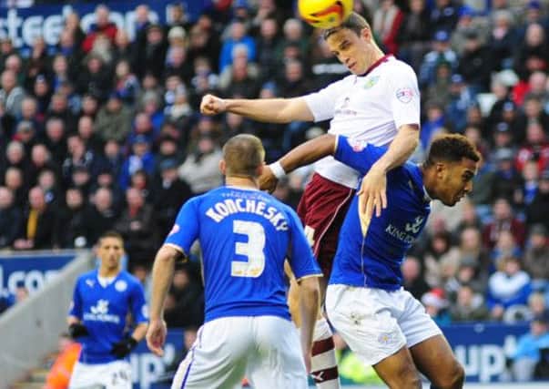 Seasoned campaigner: Michael Duff wins an aerial duel with Liam Moore at Leicester