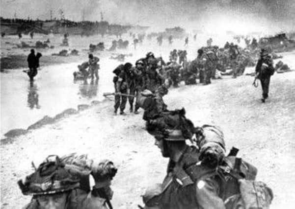 Wounded British troops helped ashore at Sword Beach, June 6, 1944, during the D-Day invasion of German occupied France during World War II.  (AP Photo)