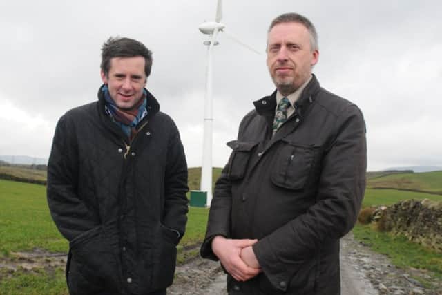 Coun. Paul White an Jon Roche with the wind turbine on Floyt Bridge Farm which will be similar to the one he wants to use in Trawen..