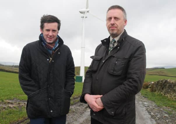 Coun. Paul White an Jon Roche with the wind turbine on Floyt Bridge Farm which will be similar to the one he wants to use in Trawen..