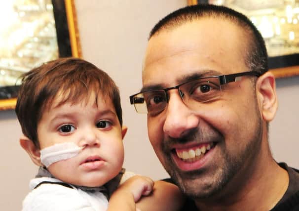 Tariq Mushtaq with his 18 month old son Muhammed. Photo Ben Parsons