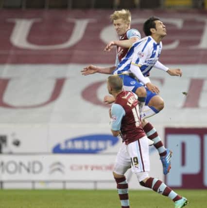 Ben Mee jumps for the ball.