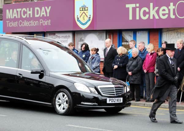 Burnley Football Club staff and fans line the street as the funeral cortege of clarets legend Arthur Bellamy passes Turf Moor.
Photo Ben Parsons