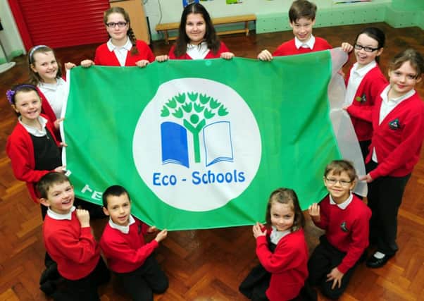Pupils at Sabden Primary School with their Eco-School green flag.
Photo Ben Parsons
