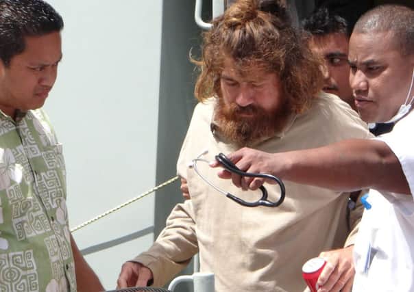 Jose Salvador Alvarenga, center, gets off a ship in Majuro, the Marshall Islands, after he was rescued from being washed ashore on the tiny atoll of Ebon in the Pacific Ocean
