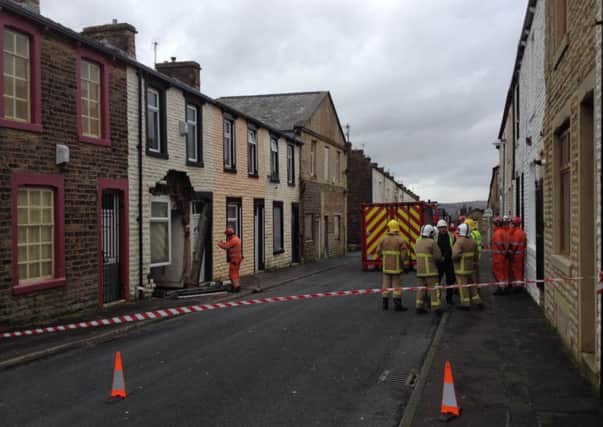 DAMAGE: Firemen attending to a partially collapsed building in Herbert Street. (S)
