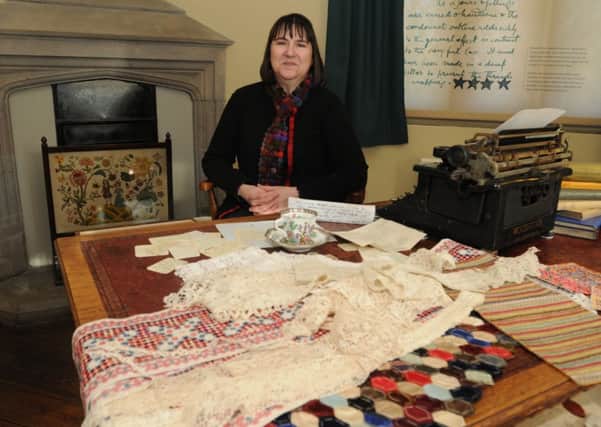 Learning Officer Jenny Waterson with some of the exhibits at the Gawthorpe Hall textile exhibition.