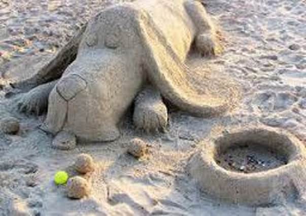 A beach sand sculpture of a dog