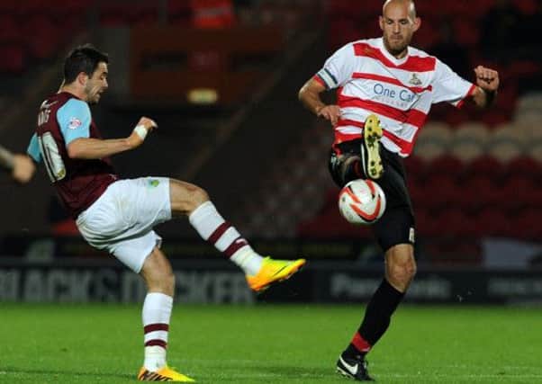 Picture: Andrew Roe/AHPIX LTD, 

Doncaster's Rob Jones gets to the ball before Burnley's Danny Ings