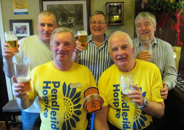 Pendleside Hospice volunteers Graham Carter and Alan Howland (front) with brewer Peter Gouldsbrough, landlord Steve Dilworth and independent brewery representative Mick Finn.