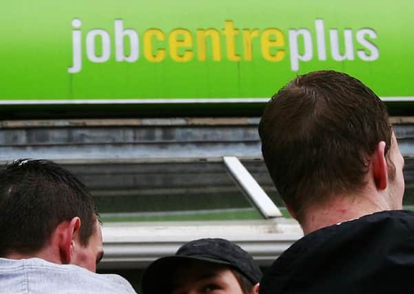 men outside a Job Centre Plus. Photo: Gareth Fuller/PA Wire