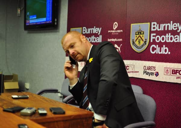 Sean Dyche answers a reporter'sphone