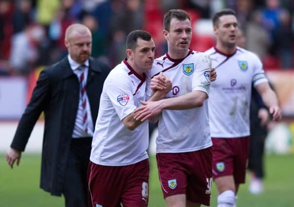 Happy camp: Dean Marney and Ashley Barnes celebrate at full-time as Sean Dyche ponders another victory