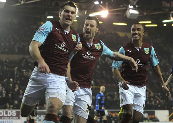 ON OUR WAY: Sam Vokes celebrates opening the scoring against Doncaster on Tuesday night with Ashley Barnes and Junior Stanislas
