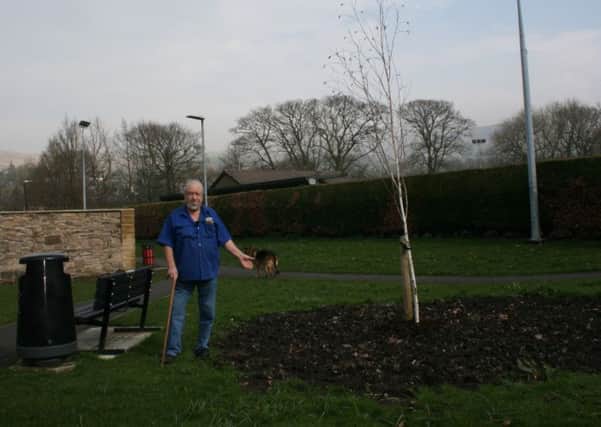 Sabden man Mr Norman Crompton beside the tree in memory of his late wife.