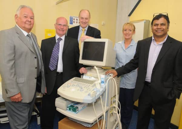 Chair of East Lancs Prostate Cancer Support Group Dave Riley, Stuart Marshall (secretary), Burnley MP Gordon Birtwistle, Tracy Cooke (clinical nurse specialist neurology) and Mr Mohan Pillai (consultant neurologist) with the old scanner.