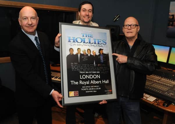 ACE Centre manager Sean Lawler, studio manager Andrea Quarin and Bobby Elliott from the Hollies present the poster to mark the recording of new material in the recording studio.