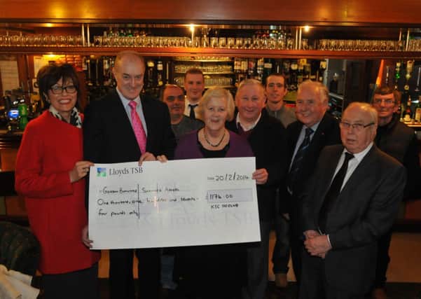 Gordon Birtwistle is presented with a cheque from members at KSC 110 Club in Burnley for the scanner appeal.