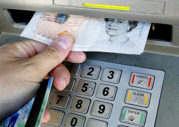 Person withdrawing money from a cashpoint. Photo: Gareth Fuller/PA Wire