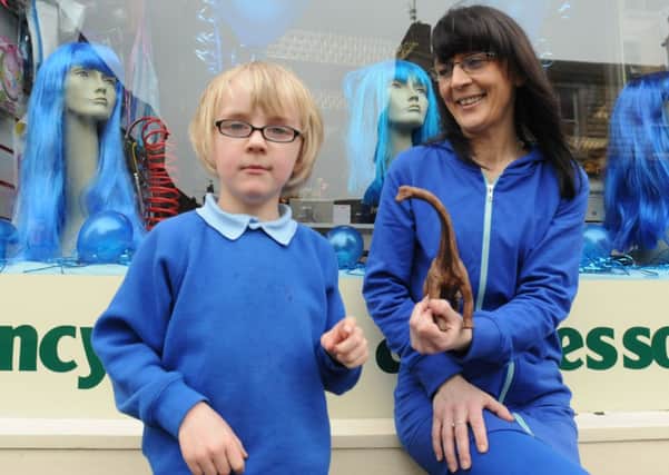 Tyler (6) and Alisa Haworth outside the Party People shop which is helping to promote Autism awareness.