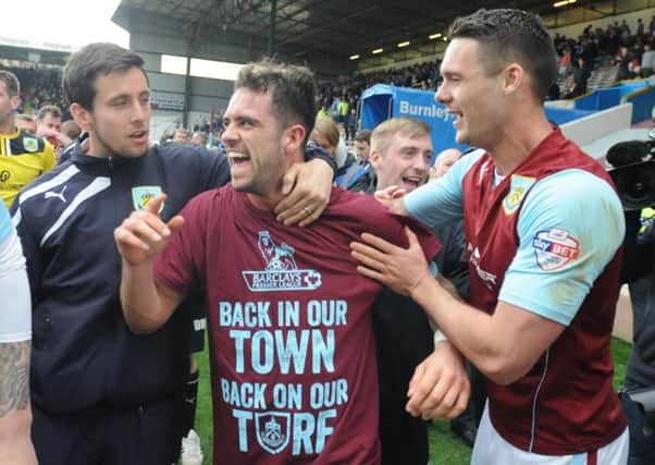 Jason Shackell celebrates promotion with leading scorer Danny Ings and Brian Stock