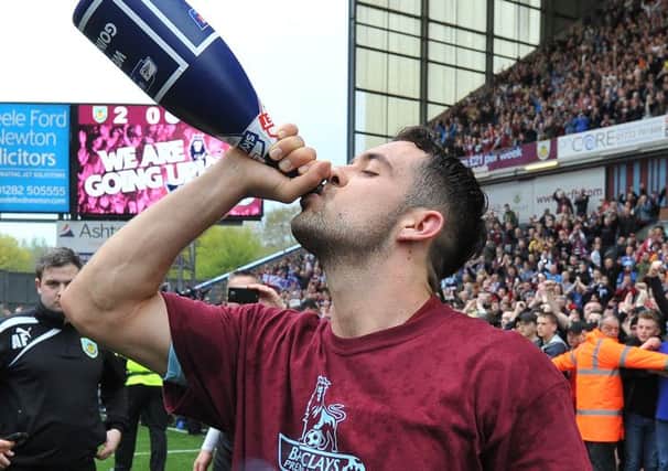 Champagne moment: Danny Ings drinks to promotion on Monday