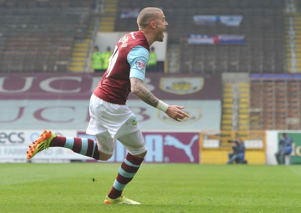 Michael Kightly turns to the crowd to celebrate as his goal fired the Clarets towards the Premier League