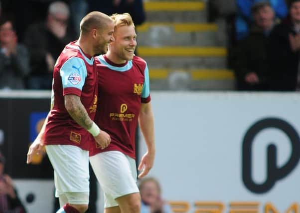 Burnley's Michael Kightly, left, celebrates scoring the opening goal with team-mate Scott Arfield