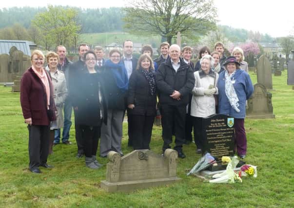 The Haworth family by the headstone