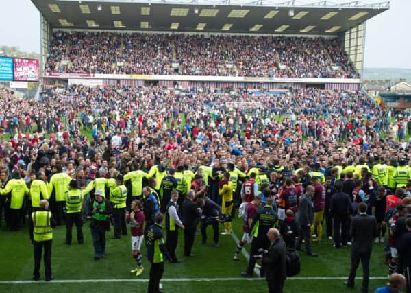 Burnley fans celebrate winning promotion to the Premier League