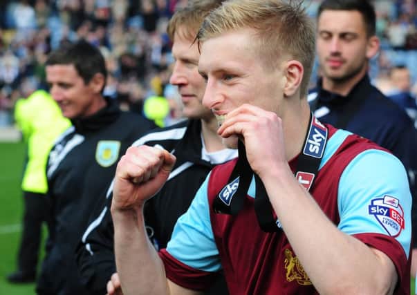 NO FEAR: Clarets defender Ben Mee bites his Championship runners-up medal after the 1-0 win over Ipswich Town at Turf Moor