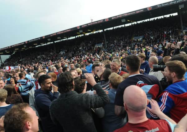 Burnley fans invade the pitch after winning promotion to the Premier League
