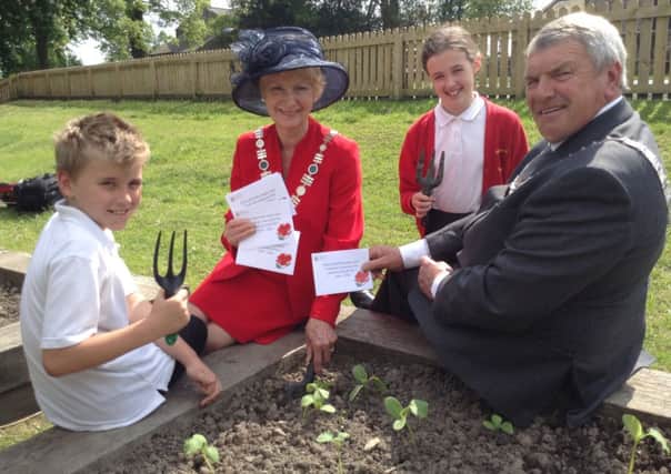 Ribble Valley Mayor and Mayoress Michael Ranson with pupils from Grindleton CE Primary School, who are sowing a poppy garden at their school.